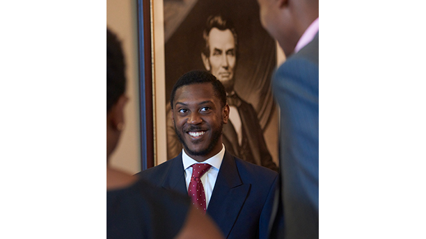 student in front of Lincoln portrait